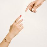 a woman's hand reaching for another woman's hand